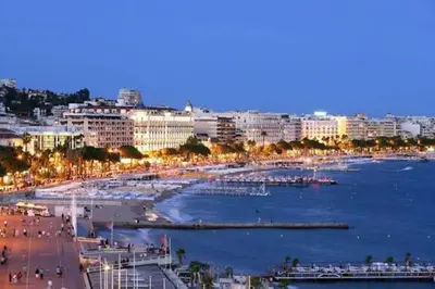 a view of a city with a beach and buildings at Cannes Front Beach Pools Apartment in Cannes
