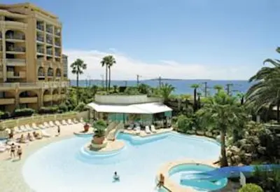 a large swimming pool at a resort with people in it at Cannes Front Beach Pools Apartment in Cannes