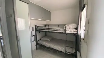 a small room with two bunk beds in it at Cannes Front Beach Pools Apartment in Cannes