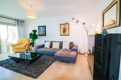 a living room with a couch and a coffee table at Central Park Apartment in Cannes