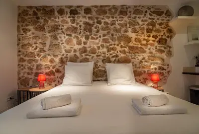 a bedroom with a large white bed with two lamps at Studio Carré d'or Cannes in Cannes