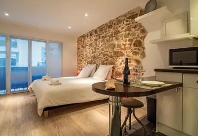 a bedroom with a bed and a table with a tv at Studio Carré d'or Cannes in Cannes