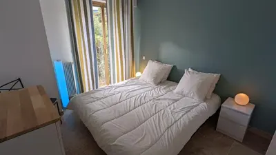 a bedroom with a white bed with a window at Eden Park 3 pièces 4 étoiles 100m des Plages Piscines SPA Parking in Cannes
