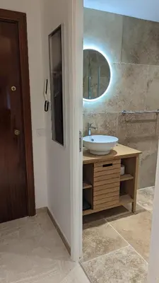 a bathroom with a sink and a mirror at Eden Park 3 pièces 4 étoiles 100m des Plages Piscines SPA Parking in Cannes