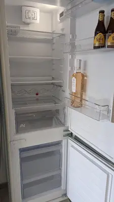 an open refrigerator with a bottle of alcohol in it at Eden Park 3 pièces 4 étoiles 100m des Plages Piscines SPA Parking in Cannes