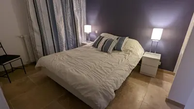a bedroom with a bed with two lamps on it at Eden Park 3 pièces 4 étoiles 100m des Plages Piscines SPA Parking in Cannes