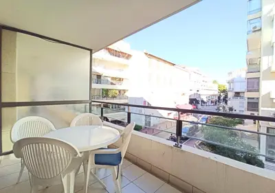 a balcony with a table and chairs and a window at Viva Riviera - Studio Jardin Florian in Cannes