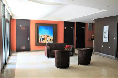 a lobby with two chairs and a poster on the wall at Viva Riviera - Studio Jardin Florian in Cannes