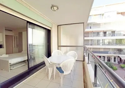 a balcony with a table and chairs on it at Viva Riviera - Studio Jardin Florian in Cannes