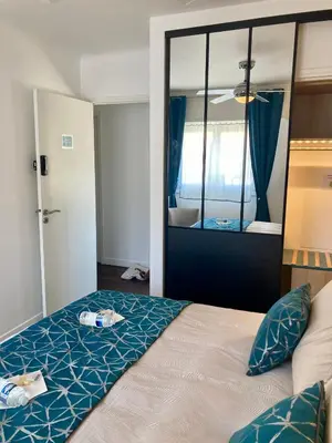 a bedroom with a bed and a mirror at Cannes City B&B in Cannes