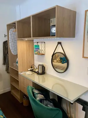 a kitchen with a desk and a green chair at Cannes City B&B in Cannes