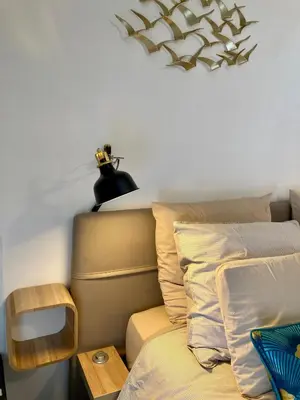 a bedroom with a bed and a lamp on the wall at Cannes City B&B in Cannes