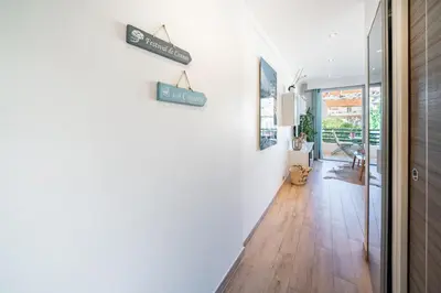 a hallway of a home with white walls and wooden floors at STUDIO by the croisette in Cannes