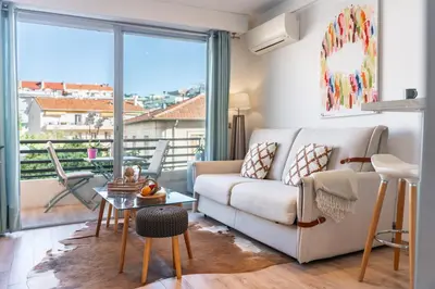 a living room with a couch and a large window at STUDIO by the croisette in Cannes