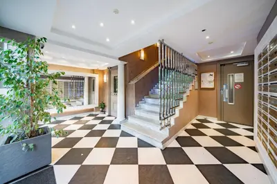 a lobby with a checkered floor and stairs at STUDIO by the croisette in Cannes