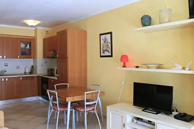 a kitchen with a table and a tv in a room at Viva Riviera Cosy and Large 2 Bedrooms with balcony in Cannes