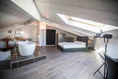 a bedroom with a bath tub and a bed in a attic at Sherlock Loft by Connexion in Cannes