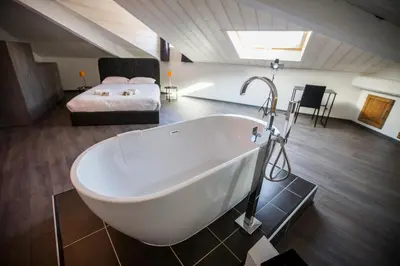 a bathroom with a bath tub and a bed at Sherlock Loft by Connexion in Cannes