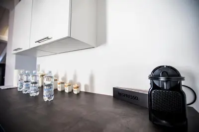a counter with glasses of water and a kettle at Sherlock Loft by Connexion in Cannes