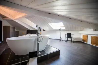 a large bathroom with a bath tub in a attic at Sherlock Loft by Connexion in Cannes