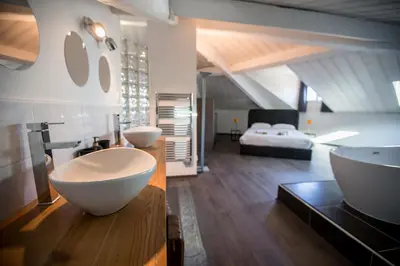 a bathroom with a tub and a sink and a bed at Sherlock Loft by Connexion in Cannes