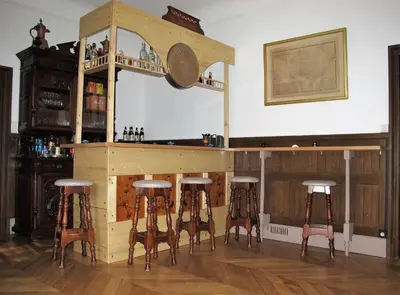 a wooden bar with four stools around it at Villa Belle Rive in Cannes