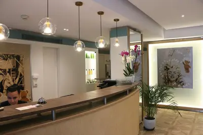 a woman sitting at a counter in a salon at Hôtel Victoria in Cannes