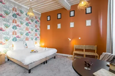 a bedroom with a bed and a table and chairs at Florella Maréchal Joffre in Cannes
