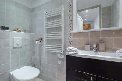 a bathroom with a toilet and a sink and a mirror at Florella Maréchal Joffre in Cannes