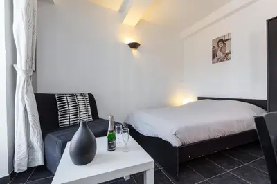 a bedroom with a bed and a table with a table sidx sidx sidx at Florella Maréchal Joffre in Cannes