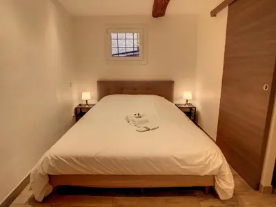 a bedroom with a bed with two lamps on two tables at 1 bedroom Forville, 4 min Palais,Plages,Croisette in Cannes