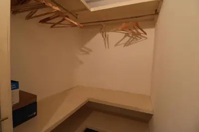 a walk in closet with a shelf and wooden beams at 1 bedroom Forville, 4 min Palais,Plages,Croisette in Cannes