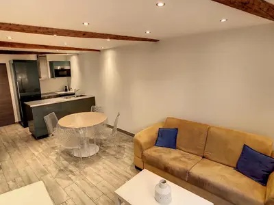 a living room with a couch and a table at 1 bedroom Forville, 4 min Palais,Plages,Croisette in Cannes