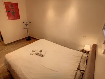 a bedroom with a bed with glasses on it at 1 bedroom Forville, 4 min Palais,Plages,Croisette in Cannes