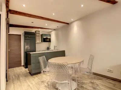 a kitchen and dining room with a table and chairs at 1 bedroom Forville, 4 min Palais,Plages,Croisette in Cannes