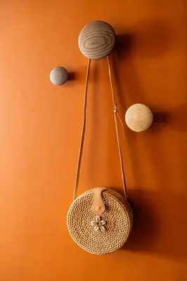 a wicker basket hanging from a wall with three lights at Hôtel Lepoussin in Cannes