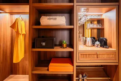 a kitchen with a cupboard with a microwave at Hôtel Lepoussin in Cannes