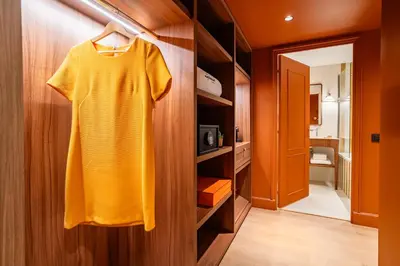 a yellow dress is hanging on a closet at Hôtel Lepoussin in Cannes