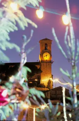 a clock tower on a building at night at Suquet26 in Cannes