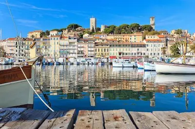 a group of boats docked in a harbor with buildings at Suquet26 in Cannes