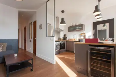 a kitchen and living room with a couch and a table at Budin Sea Cannes in Cannes