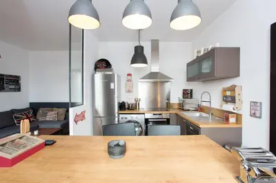 a large kitchen with a wooden table in a room at Budin Sea Cannes in Cannes