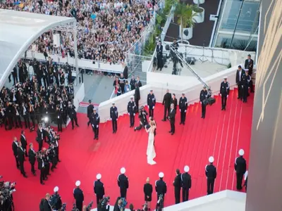 a bride and groom on the red carpet at a premiere at Suquet's Luxury Studio in Cannes