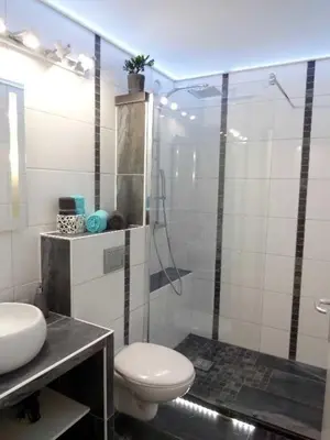 a bathroom with a toilet and a glass shower at Suquet's Luxury Studio in Cannes