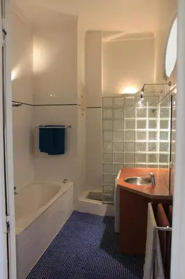 a bathroom with a sink and a tub and a shower at Le Pavillon113 in Cannes