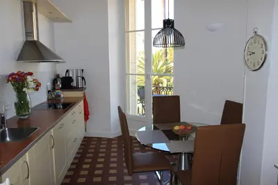 a kitchen with a table and a dining room at Le Pavillon113 in Cannes