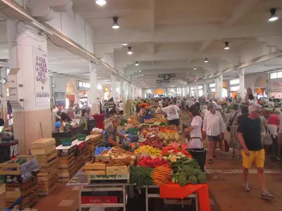 a group of people in a market with fruits and vegetables at Le Pavillon113 in Cannes