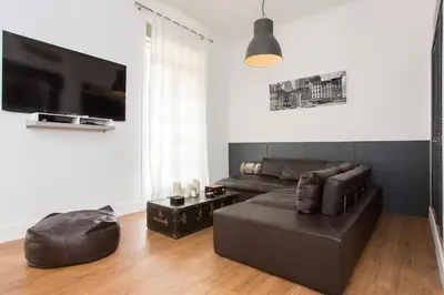 a living room with a couch and a flat screen tv at Suquet Sea Cannes in Cannes
