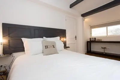 a bedroom with a large white bed with a black headboard at Suquet Sea Cannes in Cannes