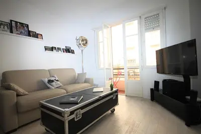 a living room with a couch and a coffee table at From Hollywood to Bollywood 2 Bedrooms 2 Bathrooms - 1 min from Croisette&Beach, 12 Min from the Palais in Cannes